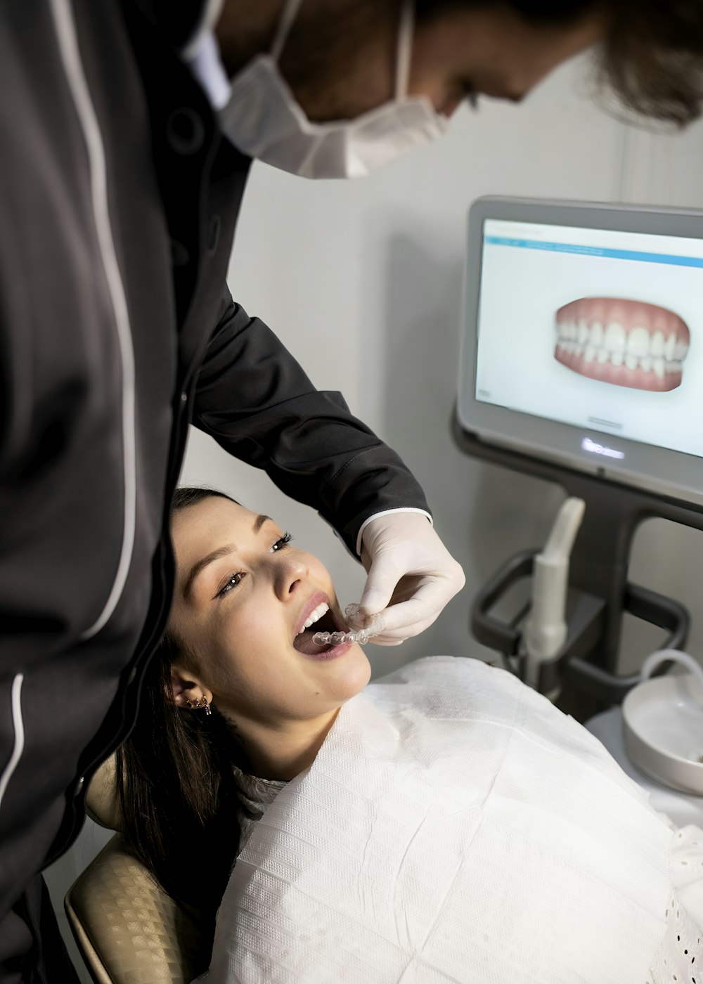 Dentist examining a patient in the operatory